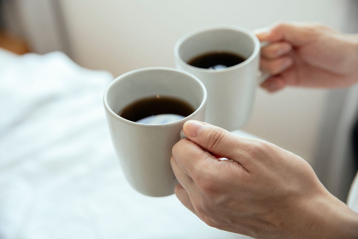 Two cups of coffee together on a table
