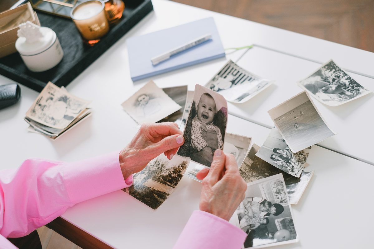 An older person looking through old photographs
