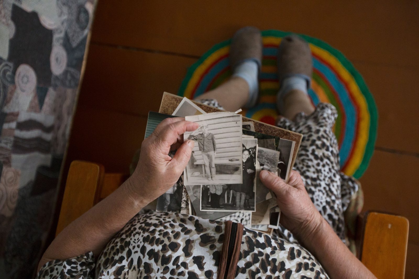 An older woman looking through old family photographs